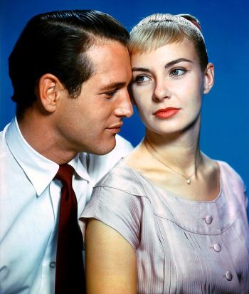 Paul_Newman_and_Joanne_Woodward_1958_cropped A publicity portrait from the movie "The Long, Hot Summer" showing Paul Newman and Joanne Woodward. Newman wears a white shirt and red tie while Woodward has short blonde hair and wears a light-colored dress, posed closely together against a blue background.