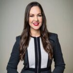 A portrait of Dr. Wildaliz Caro smiling with long dark hair.